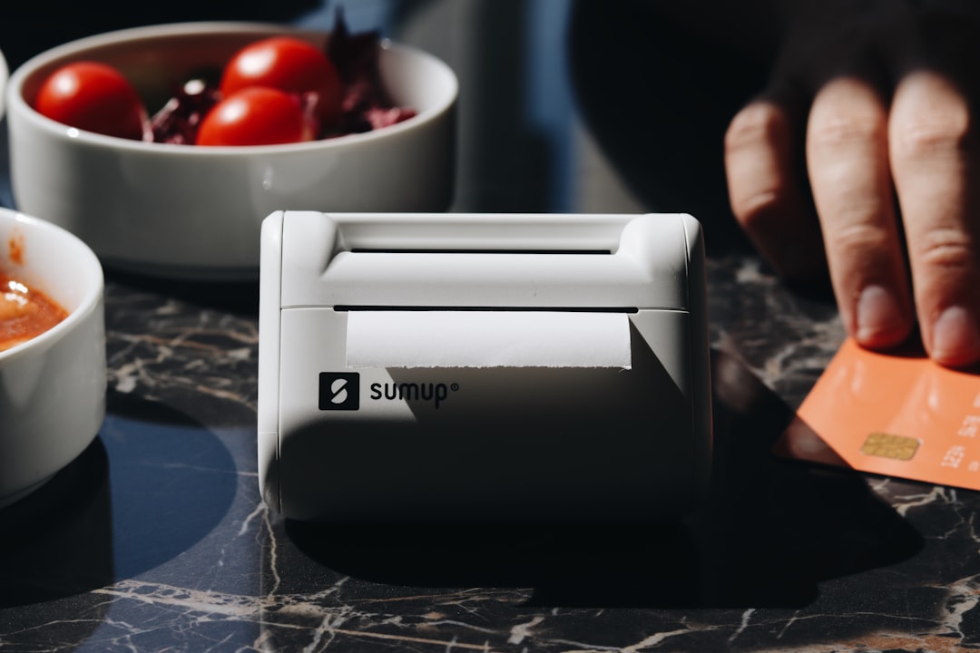 This photo showcases the SumUp Solo Printer card reader on a restaurant table, surrounded by food and coffee. Its perfect for small businesses and entrepreneurs, offering seamless payment processing in cafes and restaurants. Its sleek design and portability make it perfect for handling on-the-go transactions.